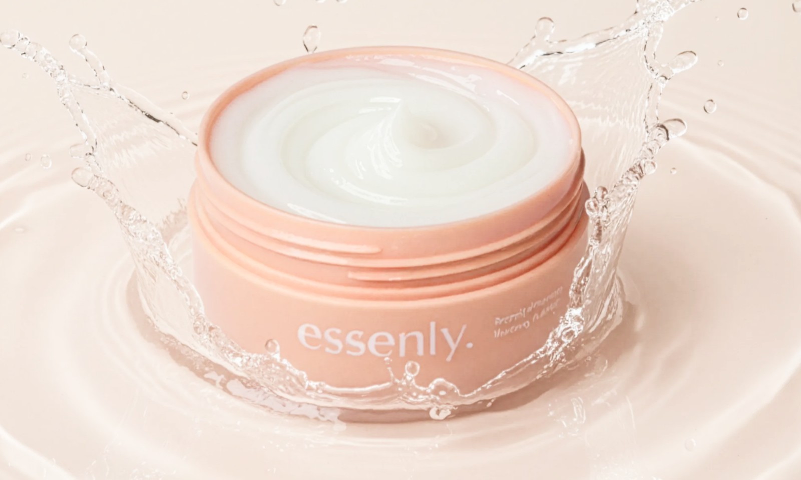 An open jar of Essenly Hair Mask with water splashing around it